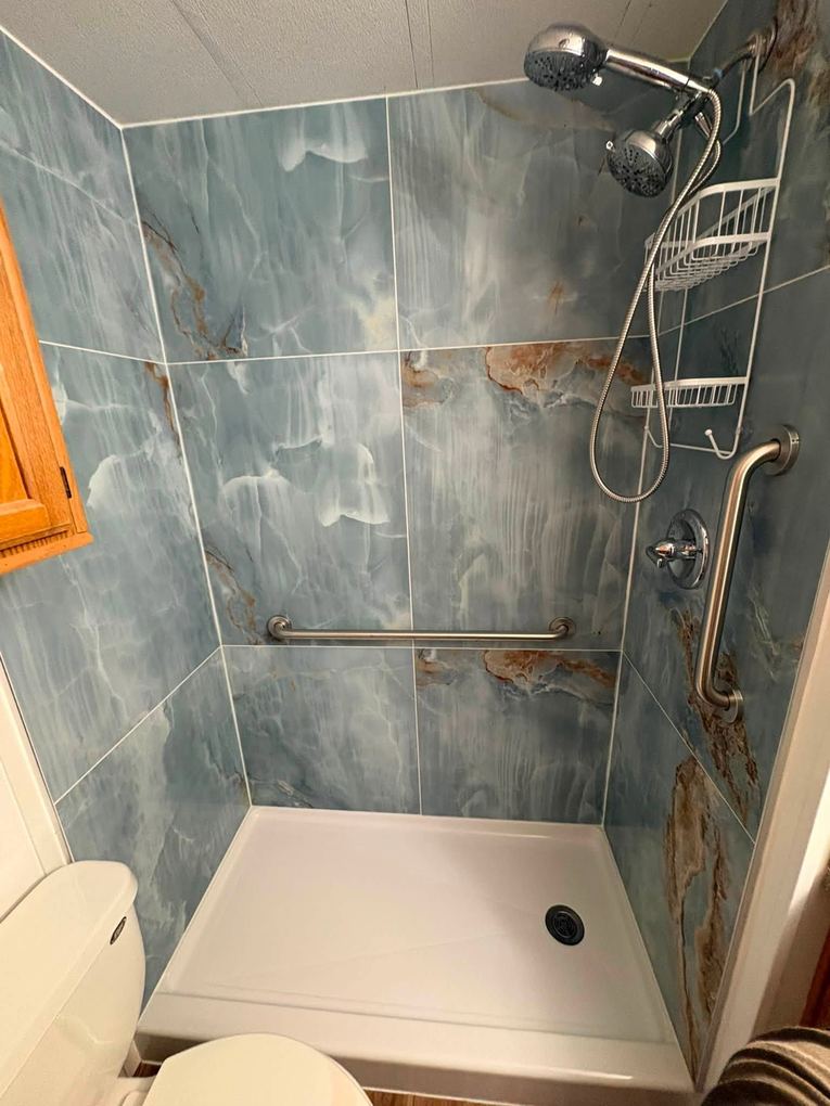 Blue marble porcelain tile shower with dual shower head and grab bars installed by No Bull Man